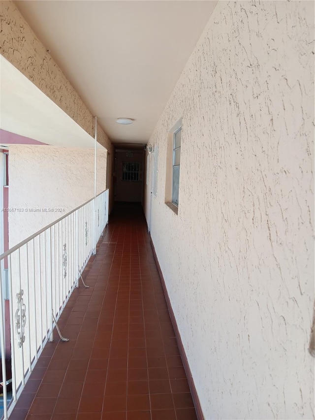 hallway featuring dark tile patterned flooring