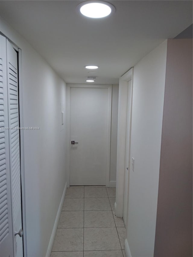 hall featuring light tile patterned floors