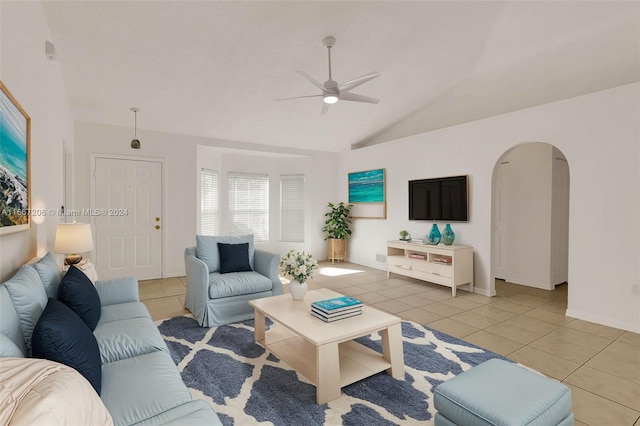 tiled living room featuring ceiling fan and vaulted ceiling