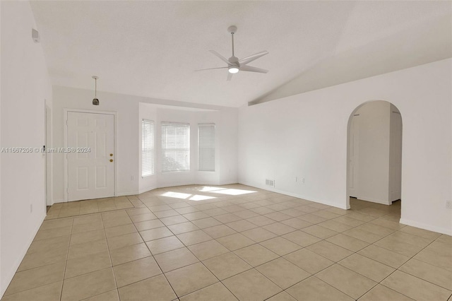 tiled spare room featuring ceiling fan and lofted ceiling