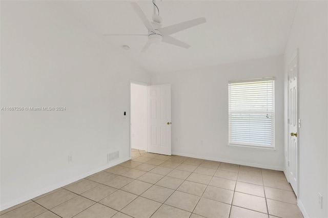 tiled empty room with ceiling fan and lofted ceiling