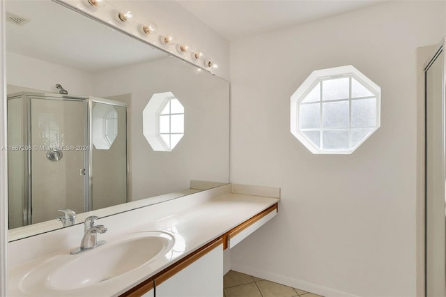 bathroom featuring walk in shower, vanity, and tile patterned flooring