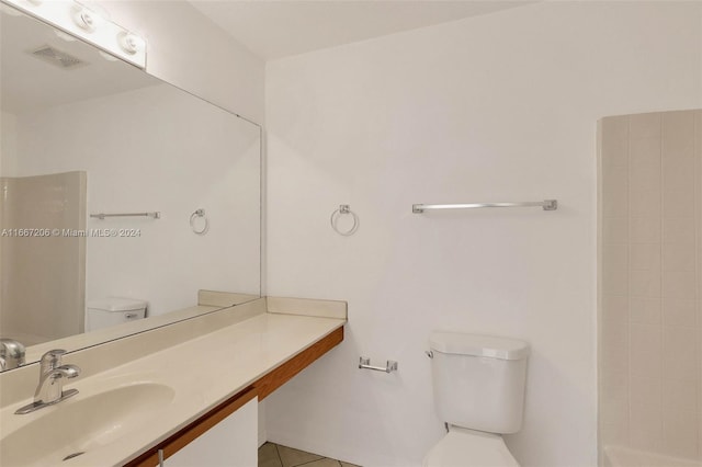 bathroom with vanity, a shower, tile patterned flooring, and toilet