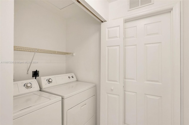 clothes washing area with separate washer and dryer