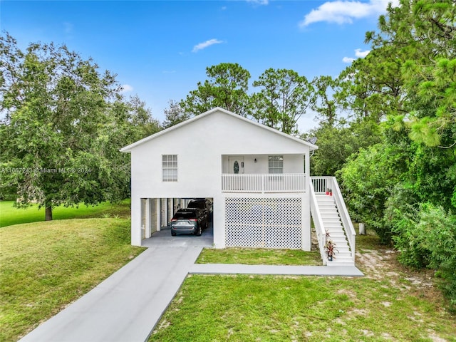 view of front of property with a front yard and a carport