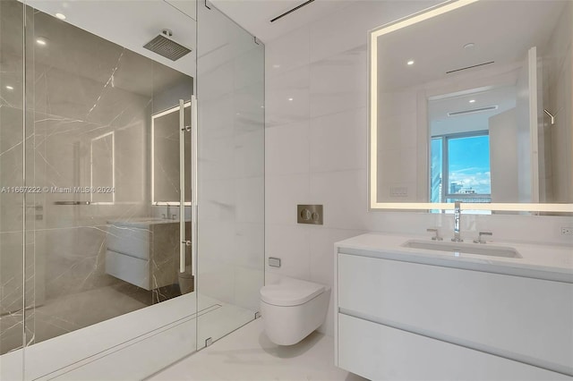 bathroom featuring vanity, tile walls, a shower with shower door, and toilet