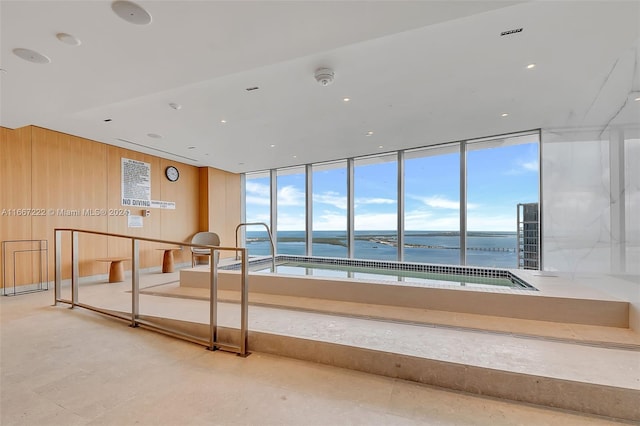 interior space featuring wood walls and a water view