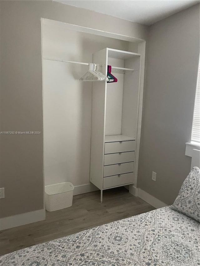 unfurnished bedroom featuring a closet and hardwood / wood-style floors