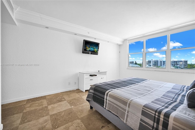 bedroom featuring floor to ceiling windows and ornamental molding