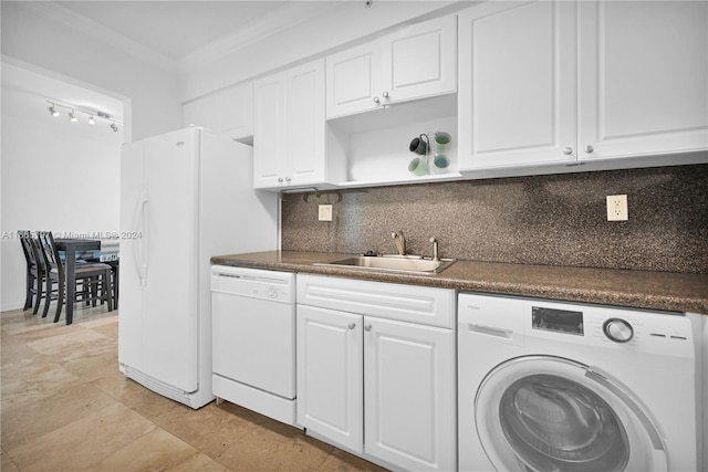 kitchen with white cabinets, dishwasher, crown molding, washer / dryer, and sink