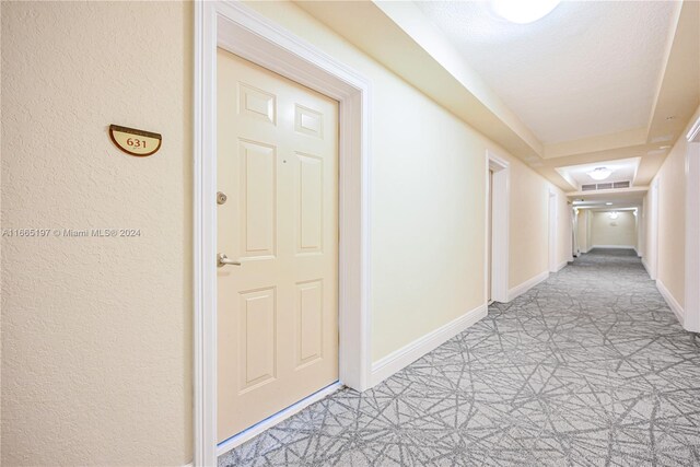 corridor featuring a textured ceiling