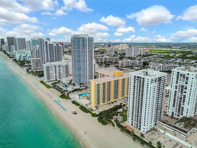 birds eye view of property with a water view and a view of the beach