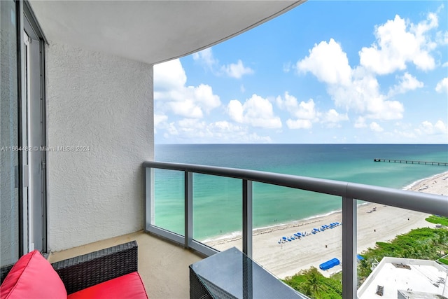 balcony with a beach view and a water view