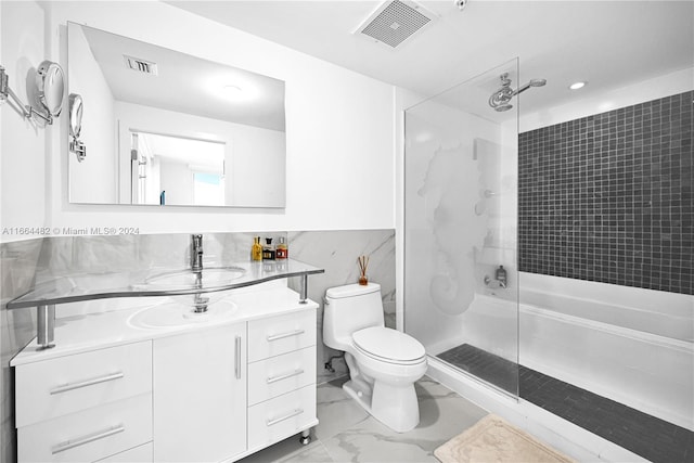 bathroom with walk in shower, vanity, and toilet