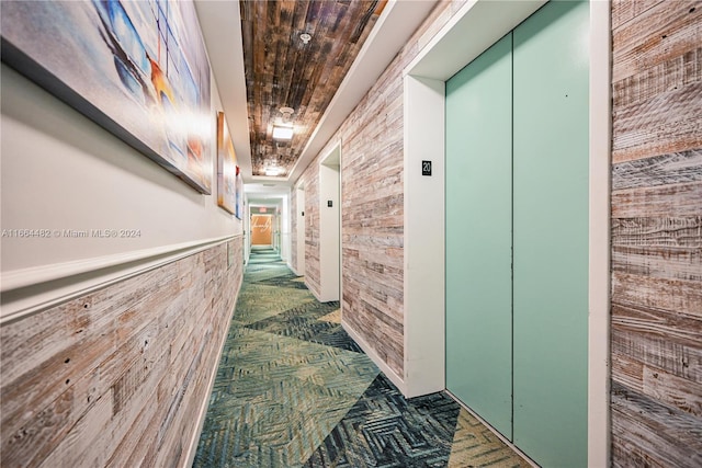 hallway with elevator and wooden ceiling