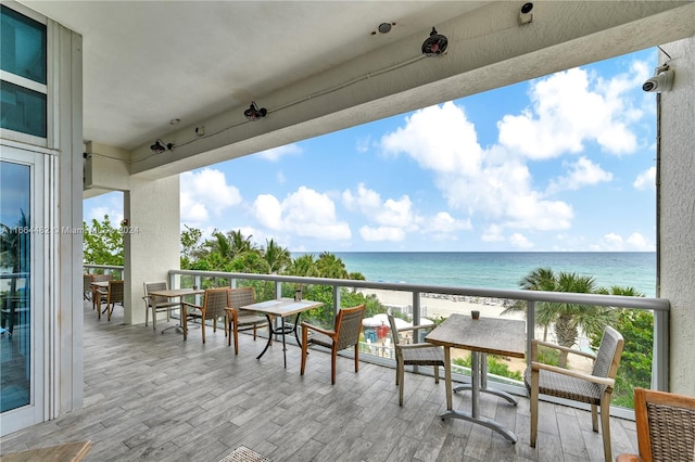 balcony with a beach view and a water view