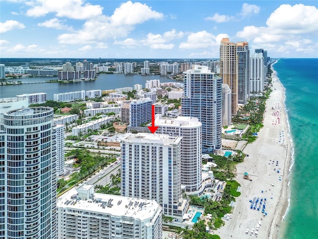 drone / aerial view with a water view and a beach view