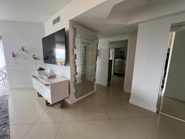 corridor featuring light tile patterned floors