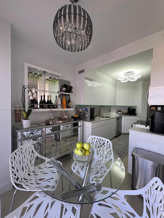 tiled living room with crown molding and sink