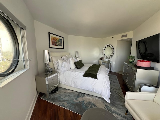 bedroom with dark wood-type flooring