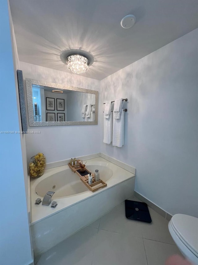 bathroom with tile patterned flooring, a bathing tub, and toilet