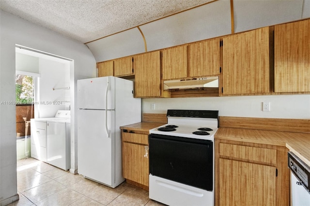 kitchen with vaulted ceiling, separate washer and dryer, white appliances, light tile patterned floors, and a textured ceiling