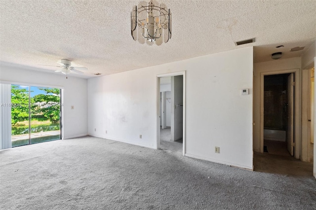 carpeted empty room with a textured ceiling and ceiling fan with notable chandelier