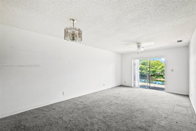 carpeted empty room with a textured ceiling and ceiling fan with notable chandelier