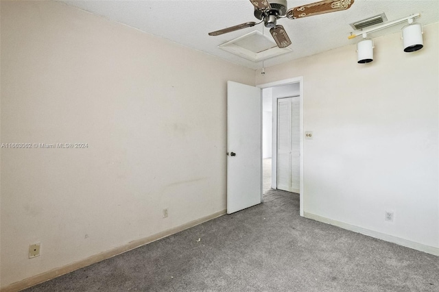 spare room featuring ceiling fan, a textured ceiling, and carpet flooring