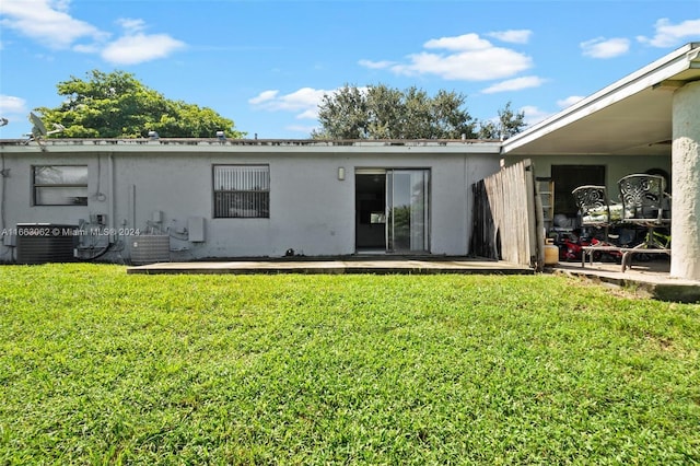 rear view of property featuring a yard