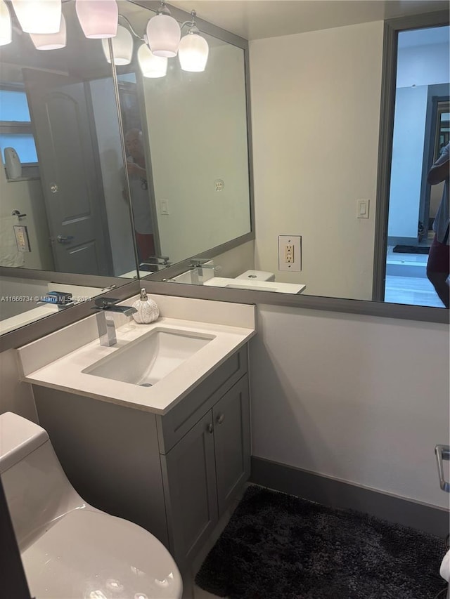 bathroom featuring vanity and toilet