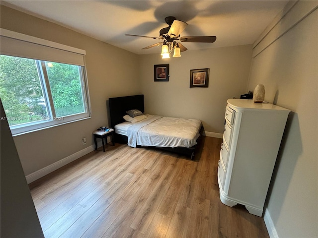 bedroom with light wood-type flooring and ceiling fan