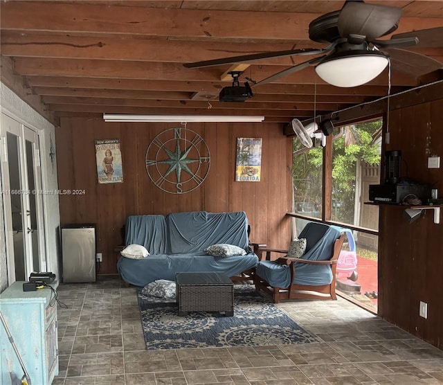 sunroom with ceiling fan, beam ceiling, and wooden ceiling