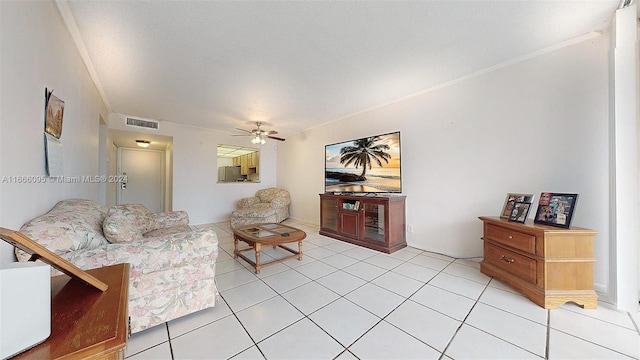 tiled living room featuring a textured ceiling and ceiling fan