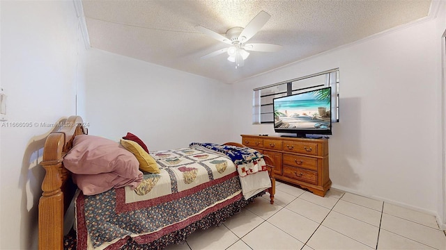 tiled bedroom with a textured ceiling, ornamental molding, and ceiling fan