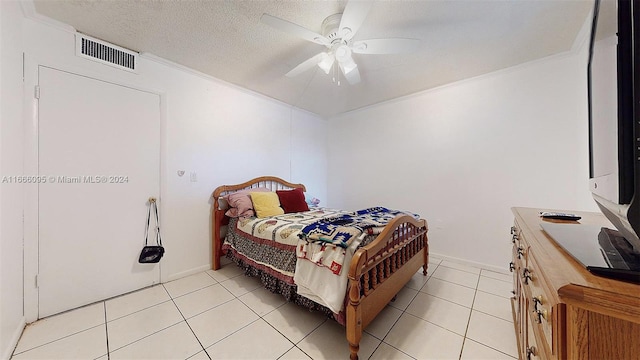 tiled bedroom with ceiling fan, crown molding, and a textured ceiling