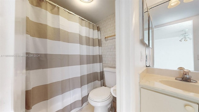 bathroom featuring vanity, toilet, and curtained shower