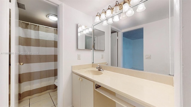 bathroom featuring tile patterned floors, vanity, and toilet