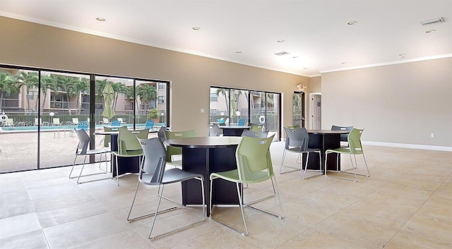 dining room featuring a healthy amount of sunlight and crown molding