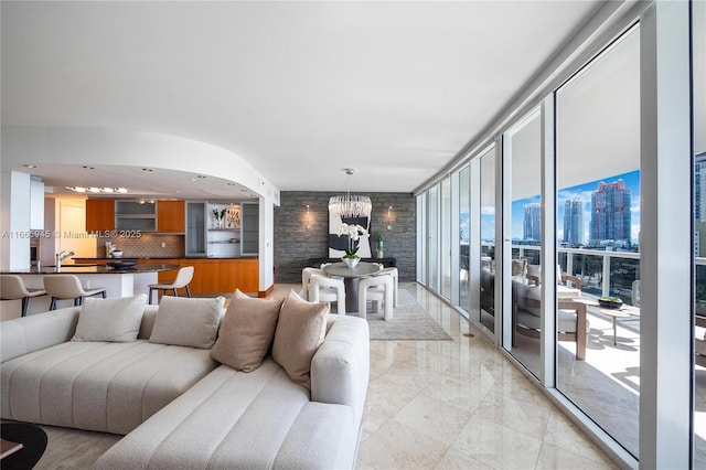 living room with a notable chandelier and floor to ceiling windows