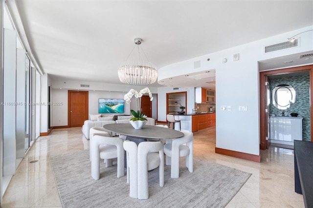 dining space with an inviting chandelier