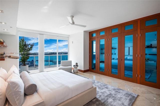 bedroom featuring floor to ceiling windows, a water view, access to exterior, and ceiling fan