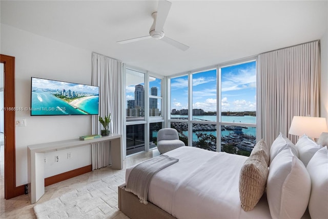 bedroom featuring ceiling fan, access to exterior, and a wall of windows