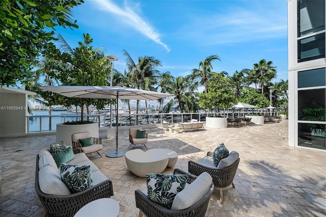 view of patio / terrace with an outdoor living space and a water view