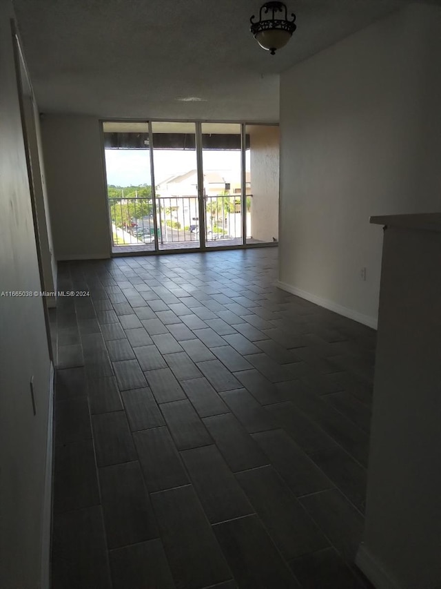 empty room featuring dark tile patterned floors