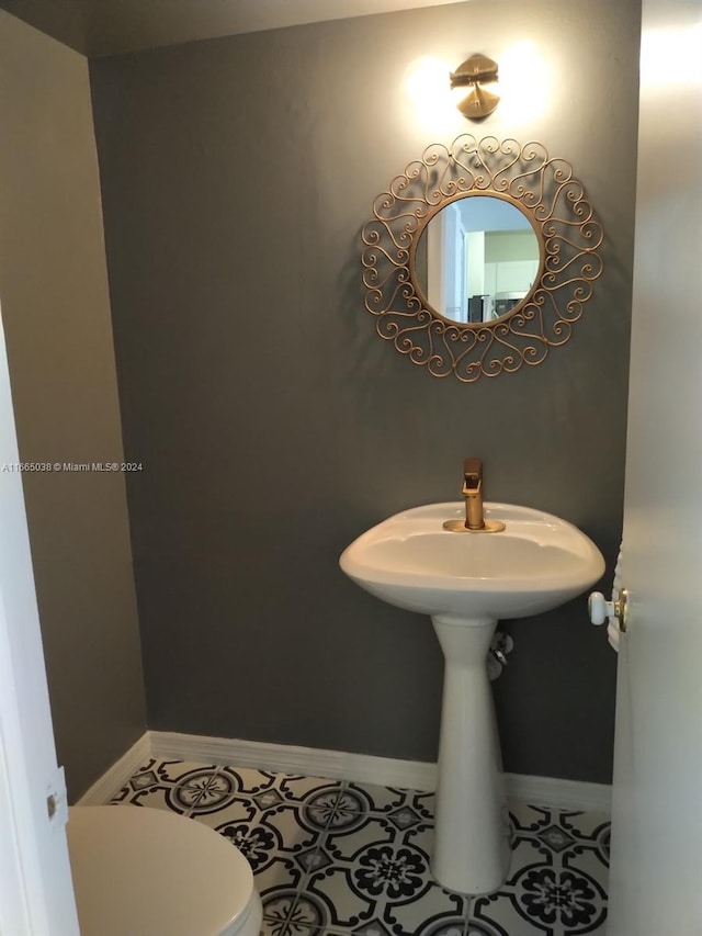 bathroom with tile patterned floors and toilet