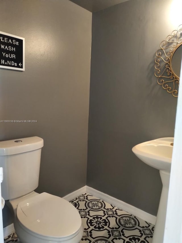 bathroom with tile patterned floors and toilet