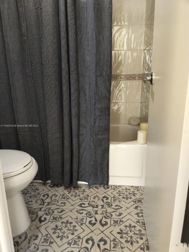 bathroom with tile patterned flooring and toilet