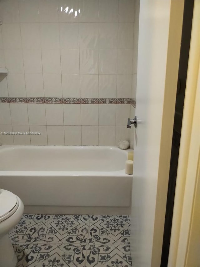 bathroom featuring toilet and tile patterned floors