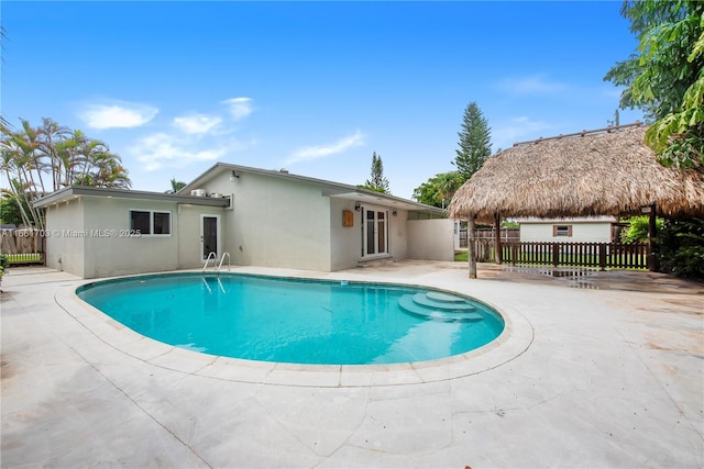 view of swimming pool featuring a gazebo, a patio area, fence, and a fenced in pool